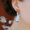 Close-up of a woman's ear wearing Bilby wooden earrings