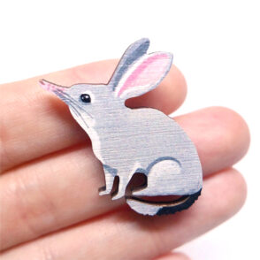 Bilby wooden brooch resting on woman's hand